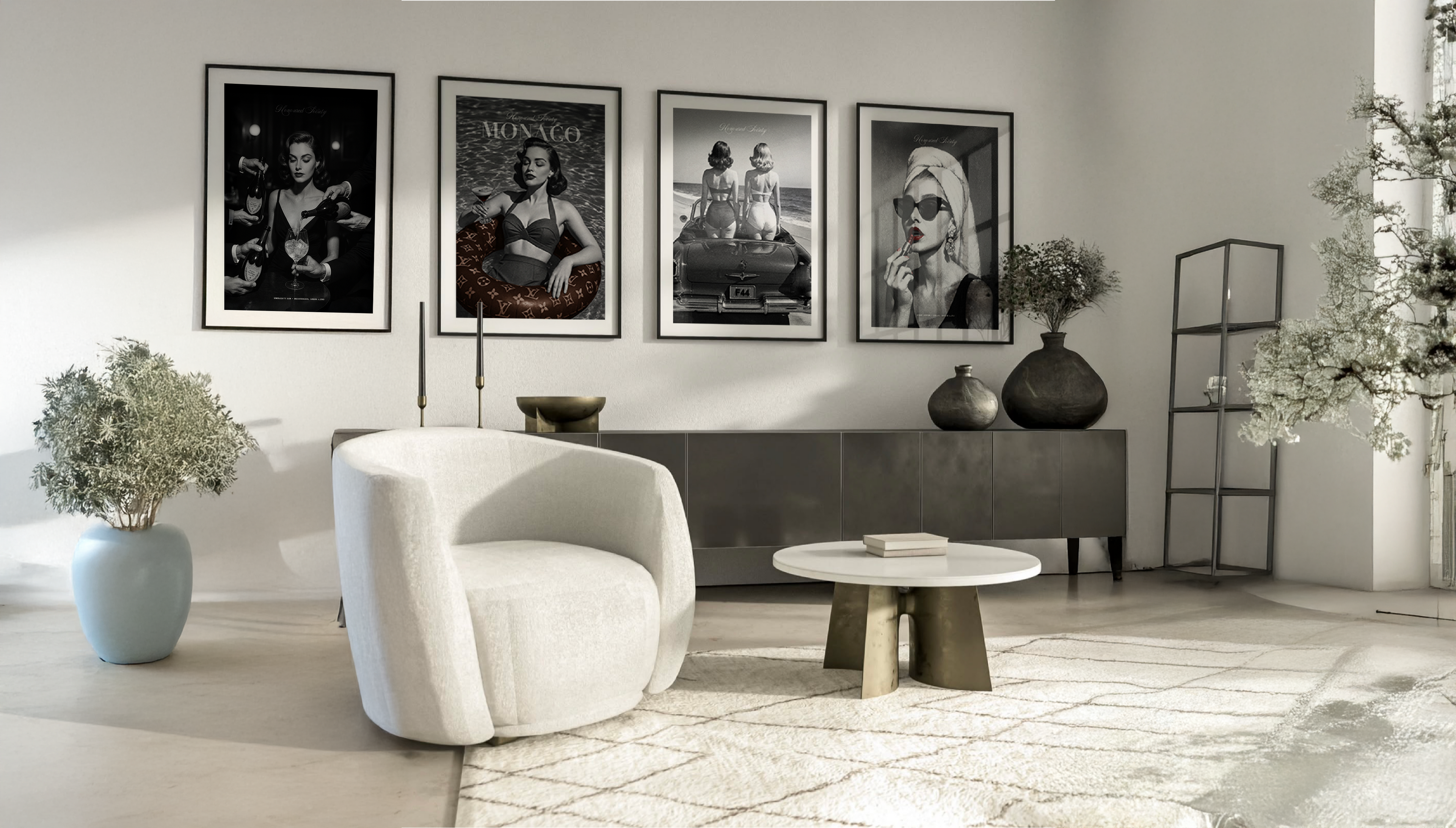 Modern living room with a white armchair, round table, and framed posters on the wall.